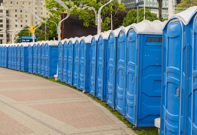 a line of portable restrooms at a sporting event, providing athletes and spectators with clean and accessible facilities in Brookhaven